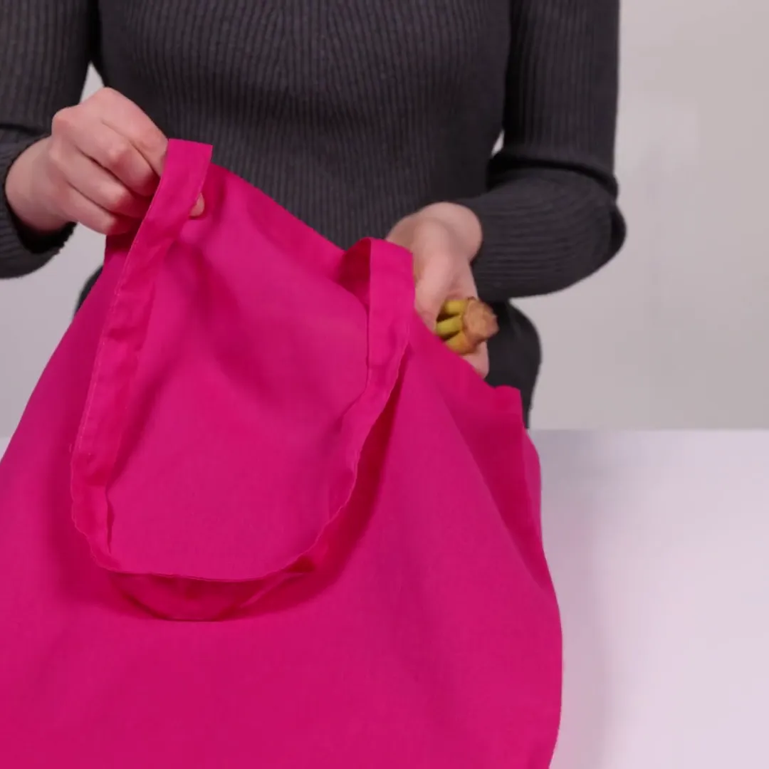 Bomullsnett, 140 g/m², vist av en person i produktvideoen – magenta
