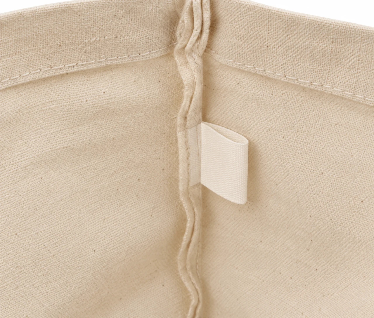 Økologisk bomullsnett, 30 × 35 cm, nærbilde av etiketten på innsiden – natur